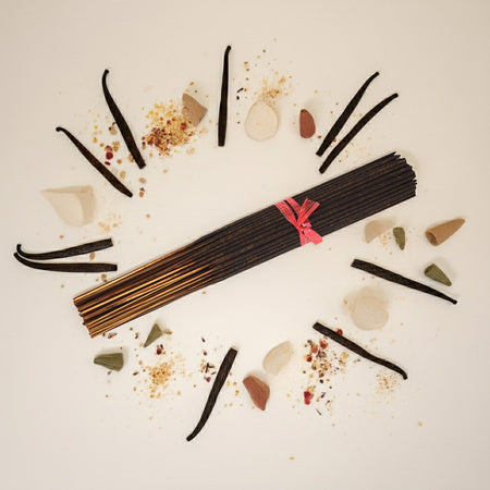 Imported Amber White Incense Sticks with vanilla beans and spices on a light background