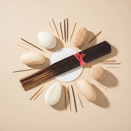 Imported Vanilla Musk Incense Sticks with decorative stones and a small dish on a beige background