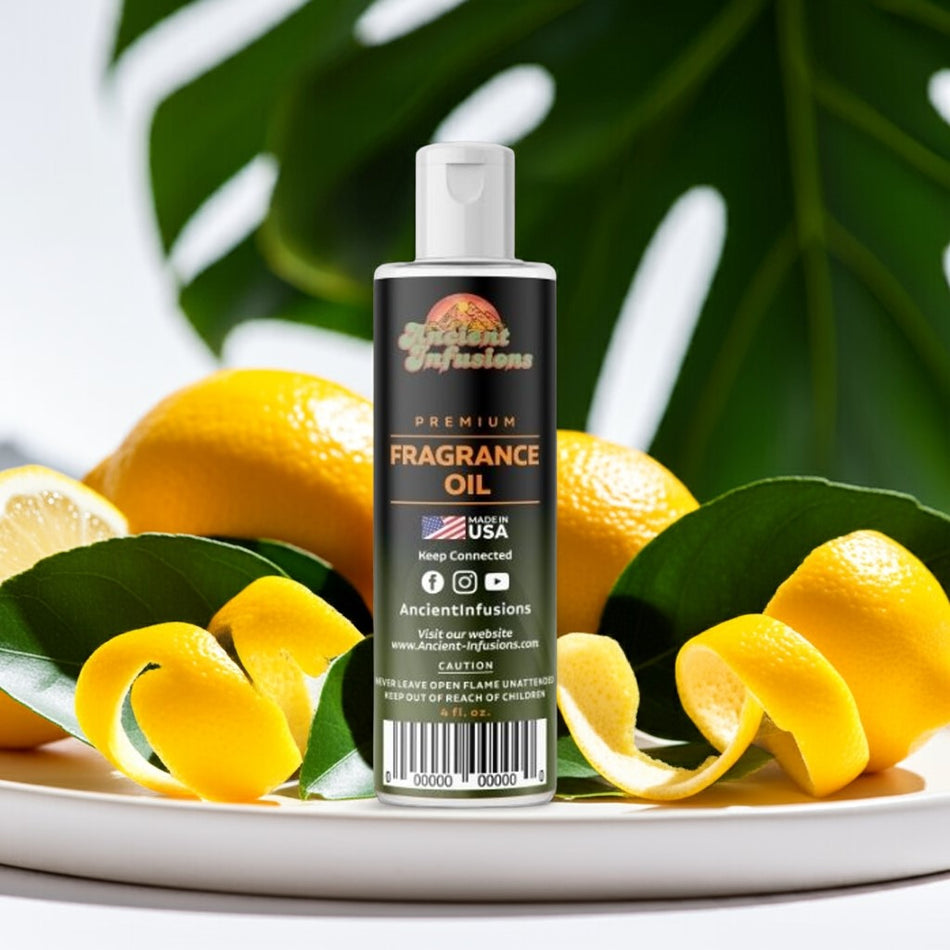 Bottle of Ancient Infusions fragrance oil surrounded by lemons and green leaves on a white plate.