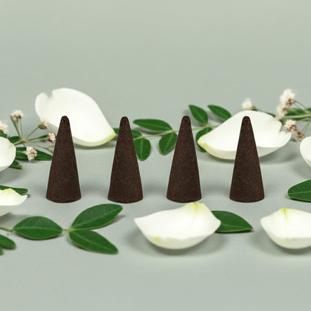 Lily of the Valley Incense Cones on a light gray surface with white flowers and green leaves.