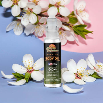 Marc Jacobs Perfect Inspired Body Oil roll-on bottle with floral accents.