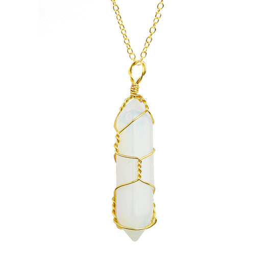 Close-up of an Opalite Necklace featuring a glowing gemstone wrapped in handcrafted gold wire with a stainless steel chain.