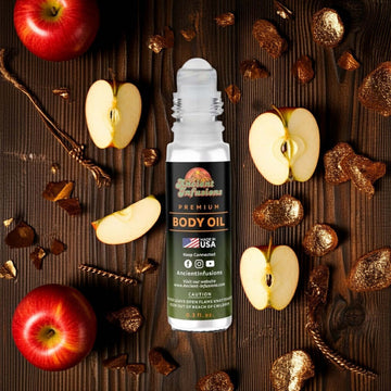 Paco Rabanne 1 Million Elixir Inspired Body Oil roll-on with apple slices and brown decorative elements on wooden background.