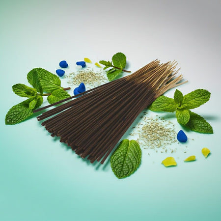 Peppermint Incense Sticks with mint leaves and small stones on a light blue background