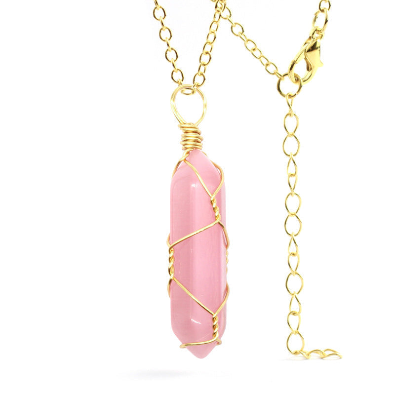 Close-up of a Pink Cat's Eye Necklace featuring a shimmering gemstone wrapped in handcrafted gold wire with a stainless steel chain.