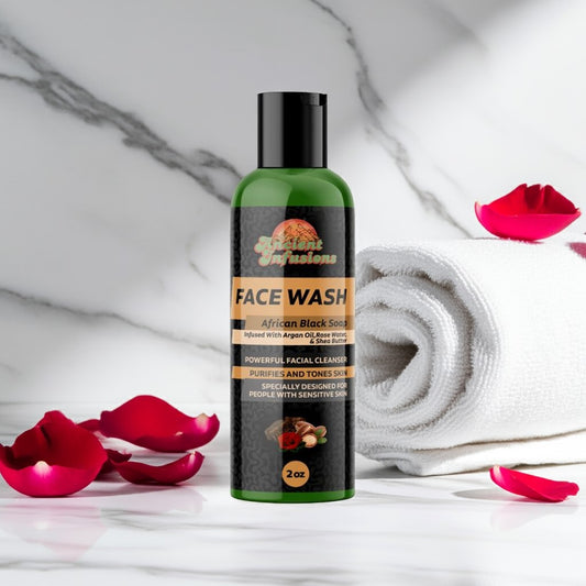 Bottle of face wash with rose petals and a towel on a marble background