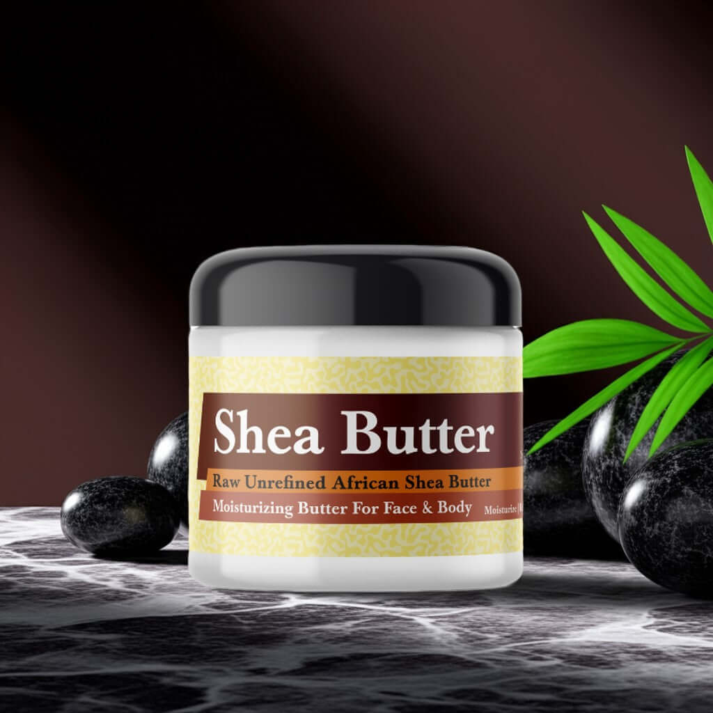 Jar of Black Butter Scented Shea Butter with organic African shea butter on marble surface with green leaves and stones