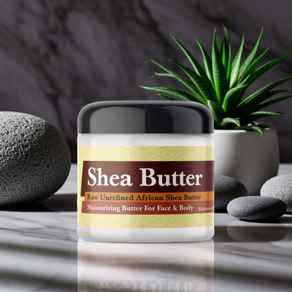 Jar of Azzaro Chrome Inspired Scented Shea Butter on marble surface with stones and plant in background.