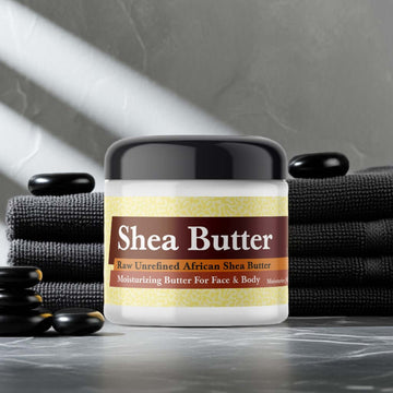 Container of Diesel Only The Brave For Men Inspired Scented Shea Butter on a spa setting with stones and towels in the background.