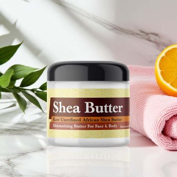 Raw African Shea Butter jar with Ed Hardy for Women Inspired Scented Shea Butter, organic and unrefined, on a spa setting.