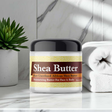 Night Queen Scented Shea Butter jar on bathroom shelf with plant and towels.