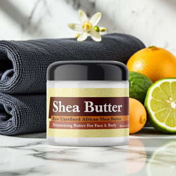 YSL Myslf Inspired Scented Shea Butter jar with citrus fruits on marble countertop.