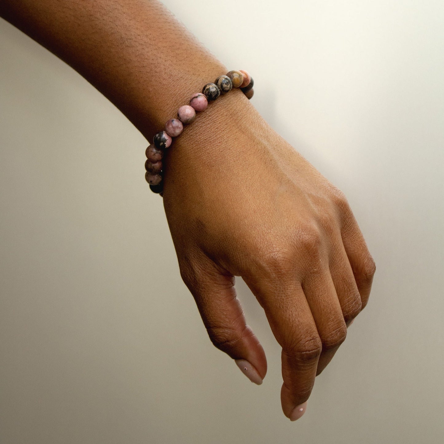 Rhodonite Bracelet Worn on Hand – Meaning and Benefits of Healing Crystals.