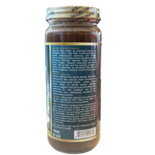 Angled view of Sea Moss Herbal Honey jar with sea moss and fresh botanicals