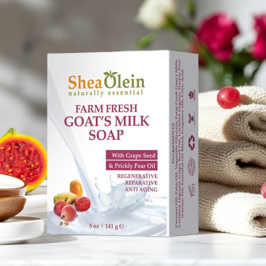 Shea Olein Goat Milk Soap on white marble counter with goat’s milk, prickly pear, and grapes – moisturizing and anti-aging bar for sensitive skin.