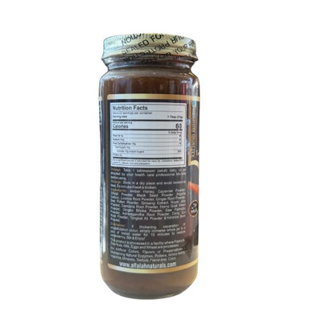 Angled view of Shilajit Herbal Honey 16 oz. jar surrounded by fresh ingredients