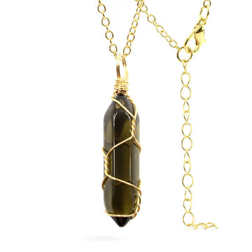 Close-up of a Smoky Quartz Necklace featuring a translucent gemstone wrapped in handcrafted gold wire with a stainless steel chain.