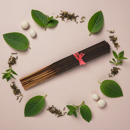 Spearmint Incense Sticks in the middle of a light colored background with leaves and herbs around them