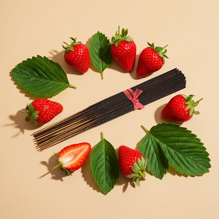 Strawberry Watermelon Incense Sticks in the center of beige background with strawberries and leaves around them