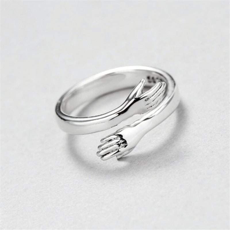 Women’s Adjustable Hugging Hands Ring in Alloy with Gold Finish – Symbol of Love and Support.